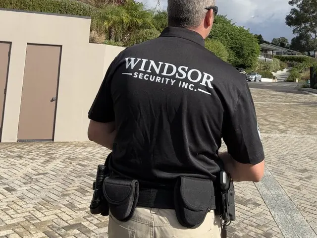 Windsor Security officer on patrol with duty belt, seen from behind